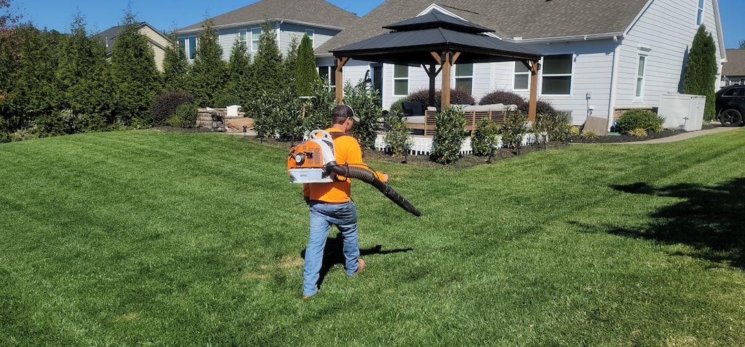 a-man-in-an-orange-shirt-holding-a-baseball-bat-ub-guntvffw